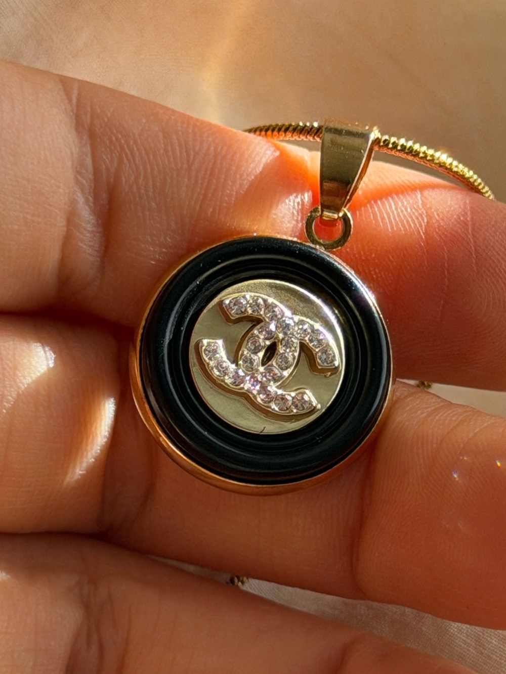 CHANEL Black and Gold Crystal CC Round Pendant Necklace